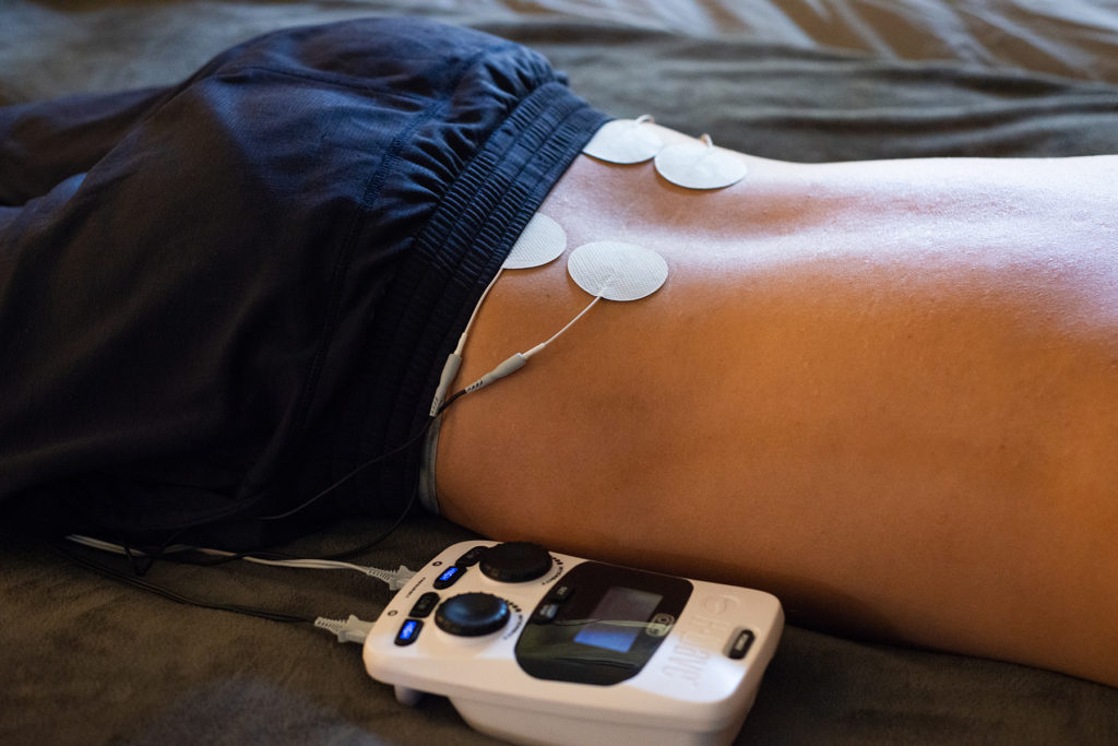 H-Wave treatment on patient recovering from low back pain post-surgery.